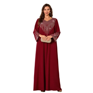 Detail of silver rhinestones on the V-neck and cuffs of a dark red maxi dress