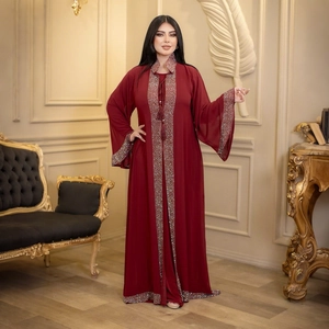 Detail of burgundy abaya featuring luxury beadwork, sequins and decorative tassels
