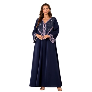 Close-up of V-neckline with purple lace trim and sparkling beads on a navy blue abaya