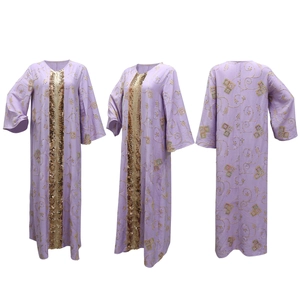 Detail of lavender kaftan featuring gold sequin trim and ethnic embroidery patterns