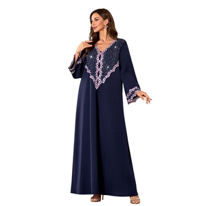Close-up of purple floral embroidery and sparkling rhinestones on the dark blue V-neck robe