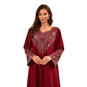 Close-up of sparkling silver rhinestones on a burgundy V-neck kaftan maxi dress
