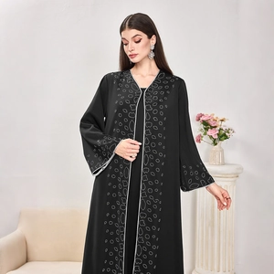 Detailed view of silver dotted patterns on the black abaya sleeves and front trim
