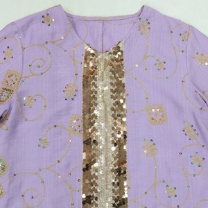 Detail of purple robe featuring gold sequins, V-neckline, and ethnic floral embroidery