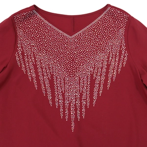 Close-up of deep red V-neck dress with sparkling rhinestone fringe tassels decoration