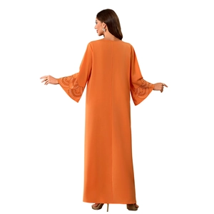 Détail de l'abaya orange montrant des manches évasées avec broderie de paillettes
