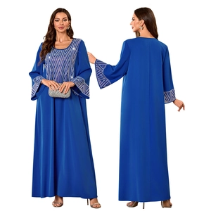 Detail of royal blue Muslim kaftan dress featuring silver geometric wave embroidery