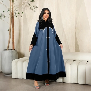 Detail of beaded velvet patchwork on a long light blue Abaya with crystal embroidery