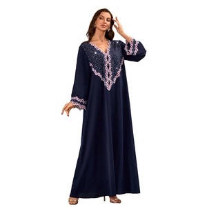 Detail of dark blue V-neck Abaya gown with pink floral lace and intricate beadwork embroidery