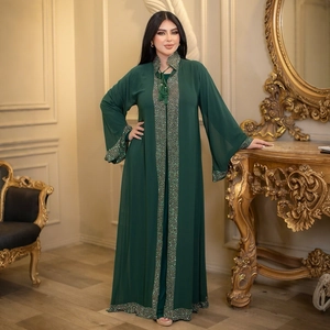 Close-up of dark green chiffon Abaya featuring intricate rhinestone and beadwork detailing