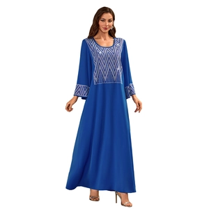Detailed silver sequin wave patterns on the neckline and cuffs of a navy kaftan dress