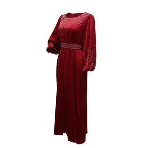 Détail d'une robe de soirée bordeaux avec strass étincelants et manches lanternes élégantes