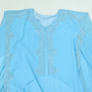 Detailed view of silver rhinestones and star patterns on sky blue chiffon dress