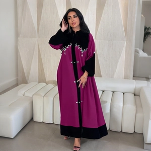 Detail of velvet patchwork abaya with emerald rhinestones and wave patterns