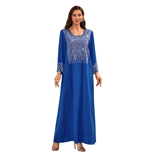 Close-up of silver sequin wave patterns on the front of a navy blue Muslim kaftan maxi dress