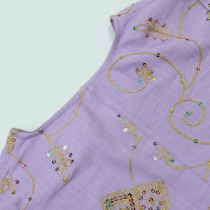 Detailed embroidery with gold thread and multi-colored sequins on purple linen fabric