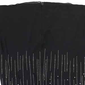 Detail view of black evening gown featuring sparkling rhinestone vertical pattern and slit