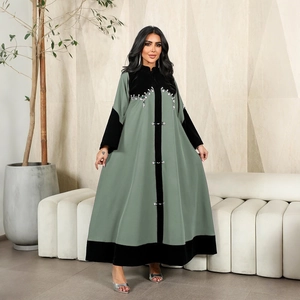 Close-up of bean green Abaya with black velvet patchwork and sparkling rhinestone embroidery