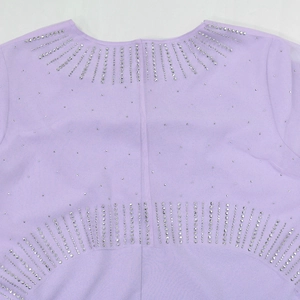 Detailed close-up of silver rhinestones on the collar of a light purple evening dress