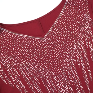 Detailed view of silver rhinestones in radial fringe pattern on a burgundy V-neck dress