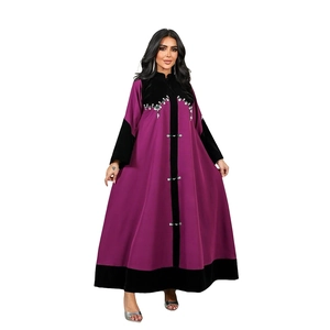Close-up of velvet paneling and intricate white rhinestone beadwork on a purple kaftan