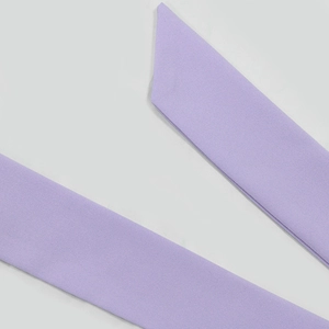 Macro detail of the light purple woven fabric belt with clean diagonal cut and texture