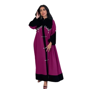 Detail of beaded velvet patchwork on a purple Abaya robe with intricate rhinestones