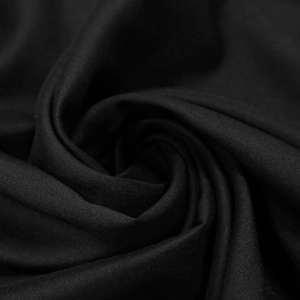 Macro view of high-density black fabric texture with soft drapes for evening gown