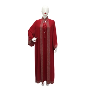 Close-up of sparkling silver rhinestones on the collar and neckline of the red abaya