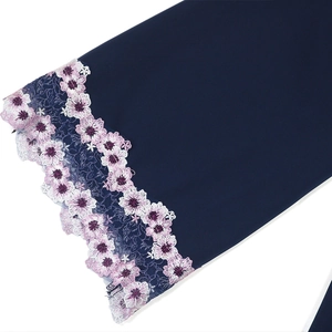 Detail of navy blue V-neck robe featuring pink floral embroidery and hollow lace trim
