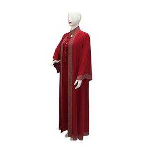 Detailed view of red party kaftan with silver rhinestones and elegant tassel pendant