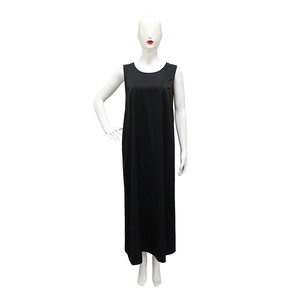 Close-up detail of a minimalist black sleeveless maxi dress with a relaxed loose fit