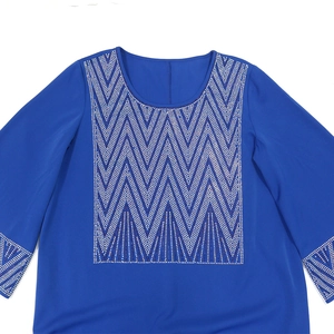 Detail of royal blue chiffon dress featuring geometric silver rhinestone patterns