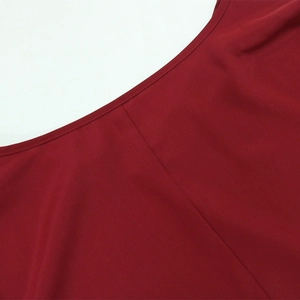 Close-up of deep red V-neckline dress with high-quality stitching and smooth fabric
