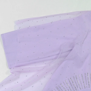 Detail of light purple mesh dress with delicate rhinestones and high-quality stitching