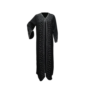 Detail of white wavy trim and silver rhinestone patterns on a black Abaya maxi dress