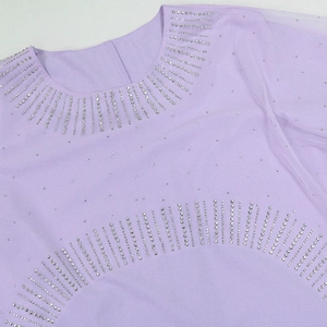 Detail of lavender purple evening dress featuring rhinestone embellishments and mesh sleeves