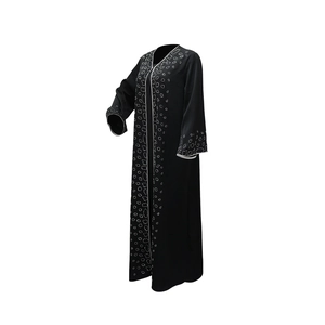 Detail of elegant black Abaya featuring white sequin embellishments on sleeves and front