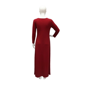 Rear view of the long-sleeved red dress on a mannequin showing seam detail and knit texture