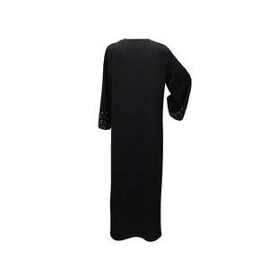 Detail of silver sequin wave patterns on sleeves of a black loose long abaya dress