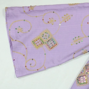 Detail of purple embroidery sleeve with gold thread patterns and colorful sequins
