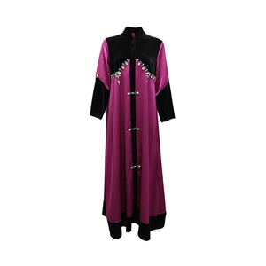 Detail of beaded embroidery and velvet patchwork on the maroon satin Abaya robe