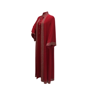 Detail view of red Abaya robe featuring sparkling rhinestone trim and tassel ties