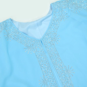 Detailed view of light blue chiffon V-neck dress with sparkling silver rhinestone patterns
