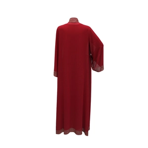 Rear view of a red kaftan dress with sparkling silver rhinestones on cuffs and hem