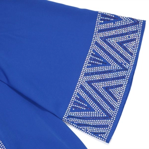 Detailed view of silver and purple rhinestones on a dark blue Muslim dress sleeve