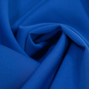 Detailed macro shot of premium royal blue breathable fabric with soft drape and texture