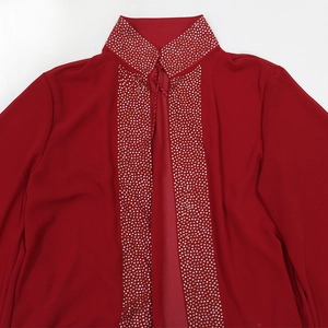 Detailed view of red chiffon robe with sparkling rhinestone trim on collar and front placket