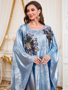 Close-up of light blue satin dress featuring intricate sequin floral embroidery details