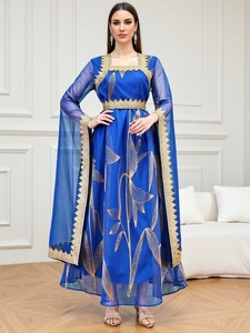 Detail of navy blue abaya with gold floral embroidery and intricate lace trim finishes